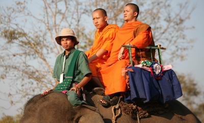 Monks enjoying elephant ride